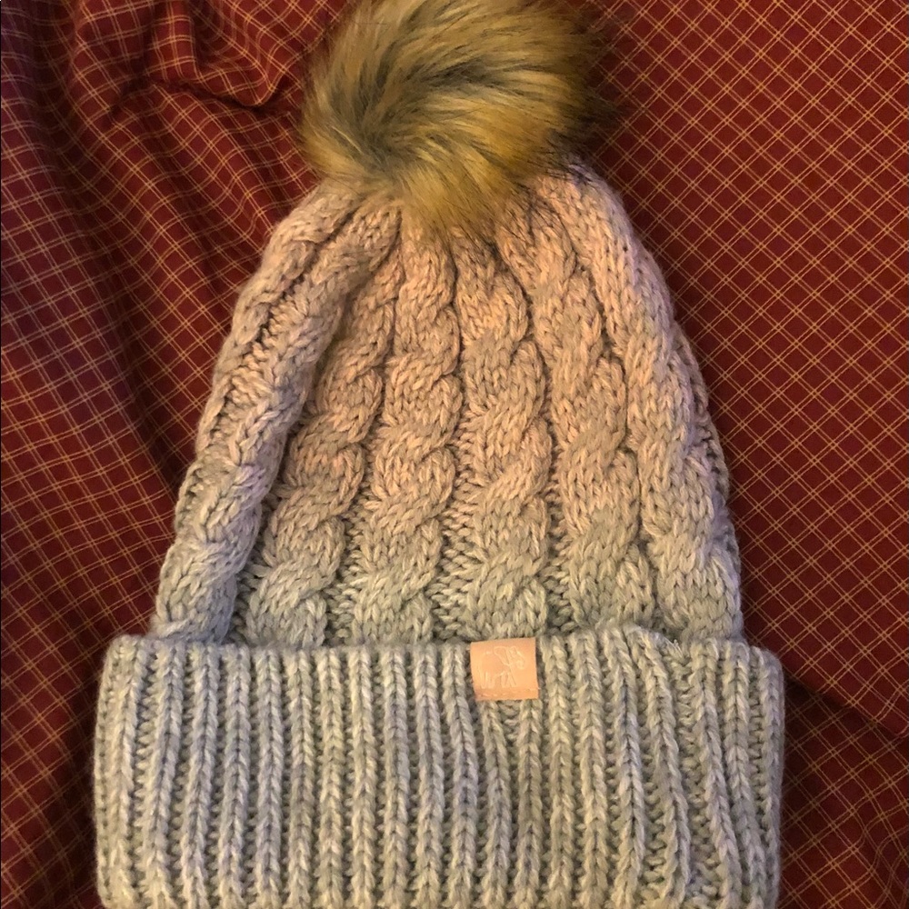 Adorable pink and gray women’s hat, With a fluffy furry ball on top.